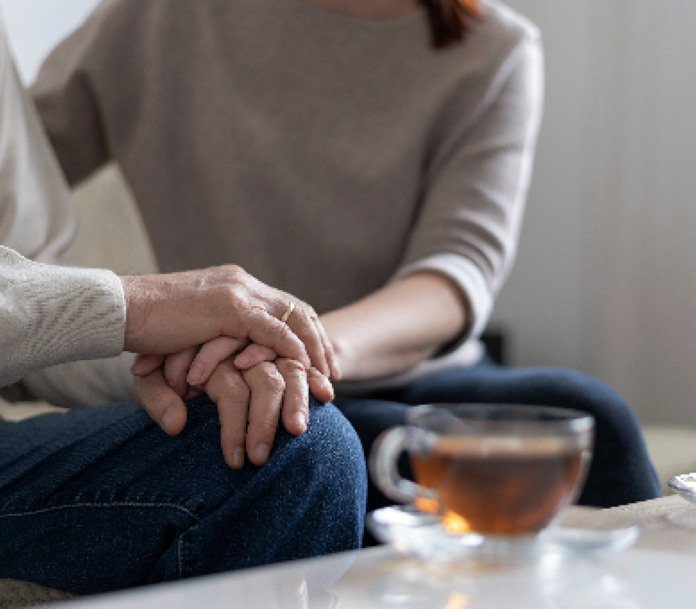 Carer holding hands with elderly man